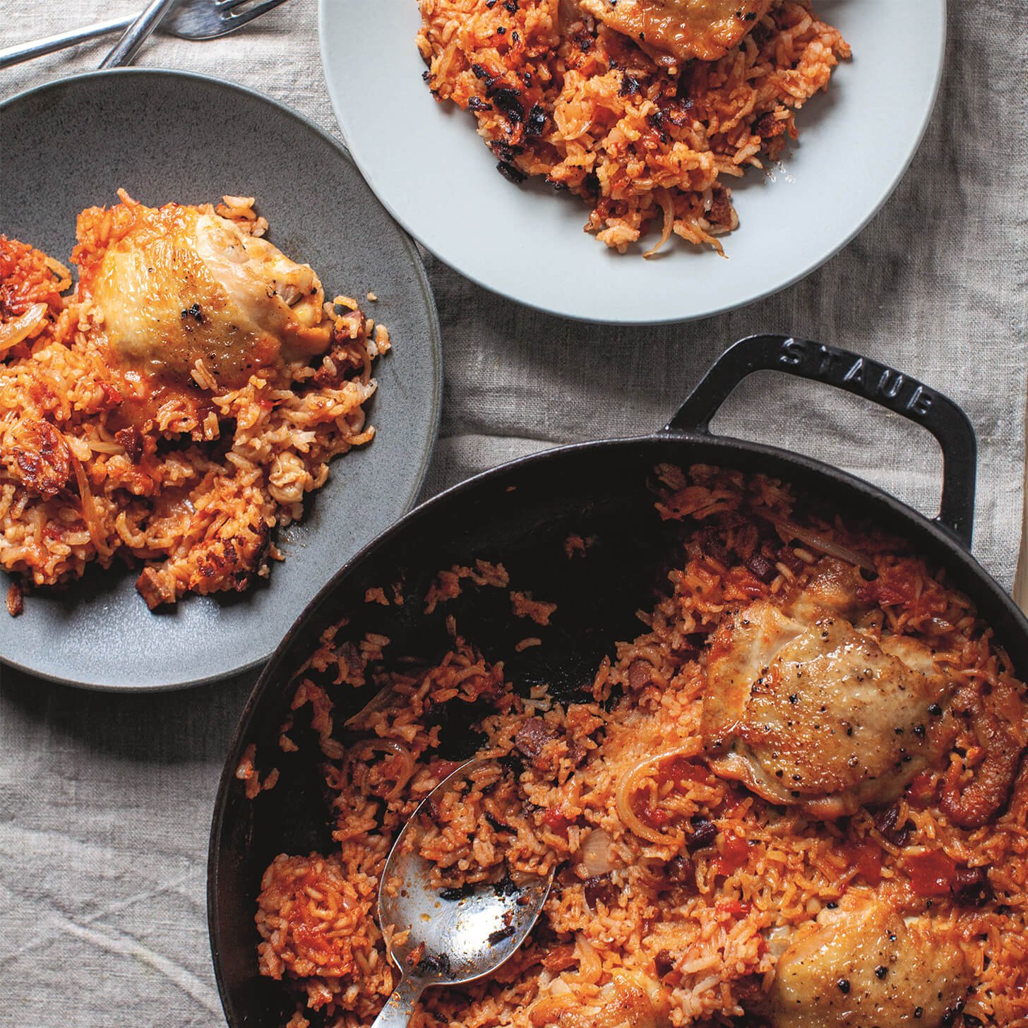 A pan with an easy one-pot recipe for a rice, chorizo and chicken thighs