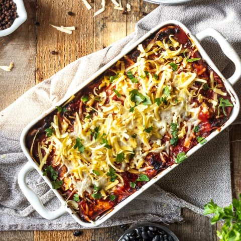 Butternut squash and black bean enchiladas baked in rich enchilada sauce