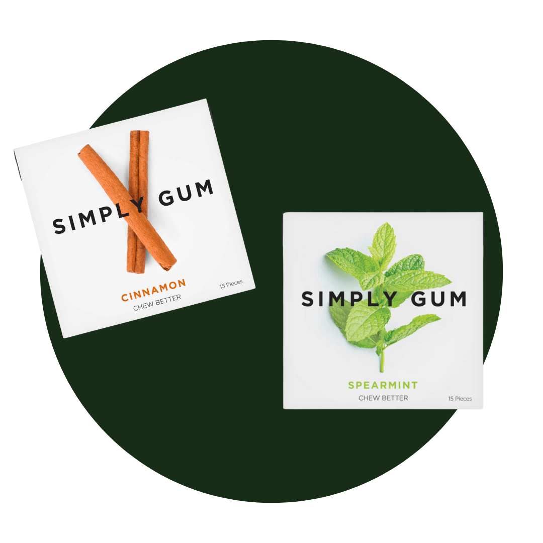 Two packs of gum on a dark green circle