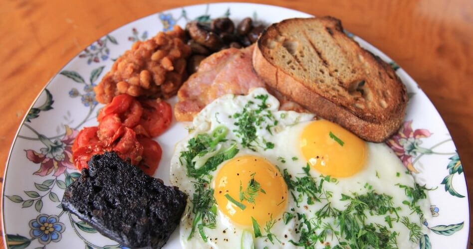 A full English breakfast on a floral plate