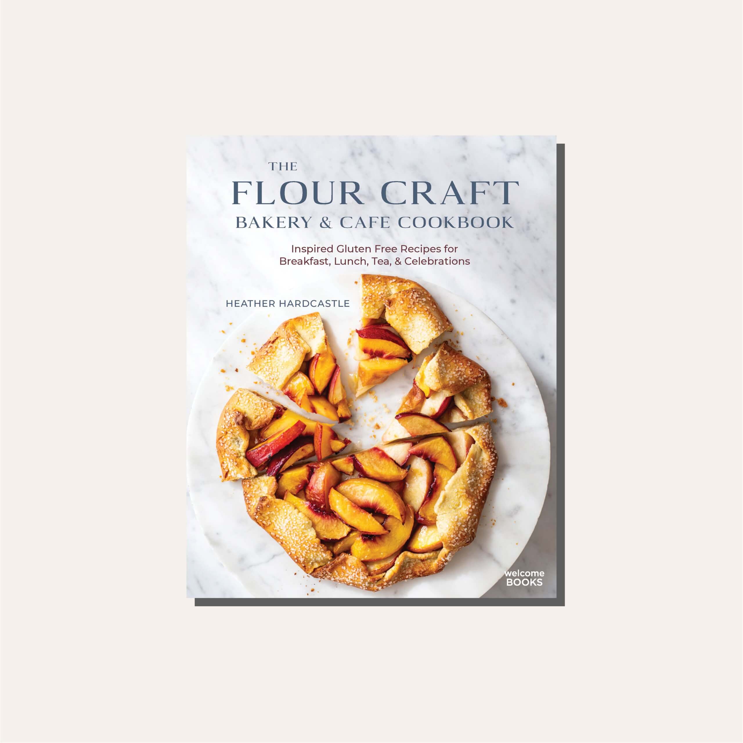 A cookbook cover with a peach galette in a light tan frame