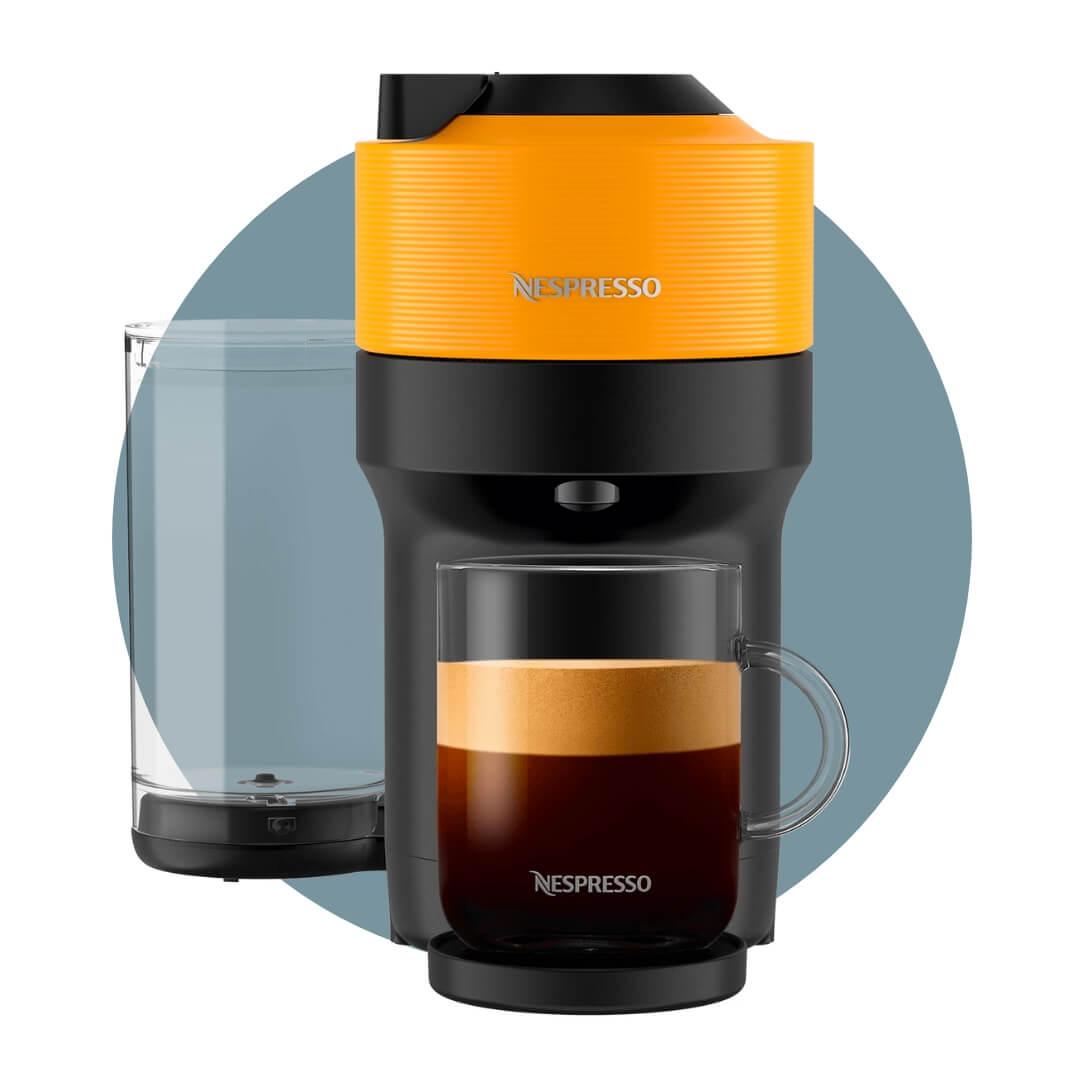 A black Nespresso coffeemaker with bright orange detailing and a cup on the stand over a blue circle graphic