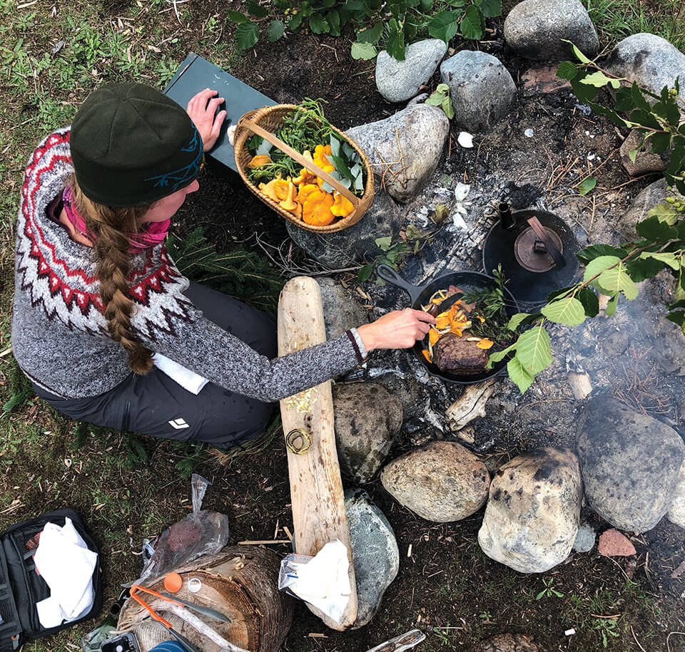 A woman cooking outdoors