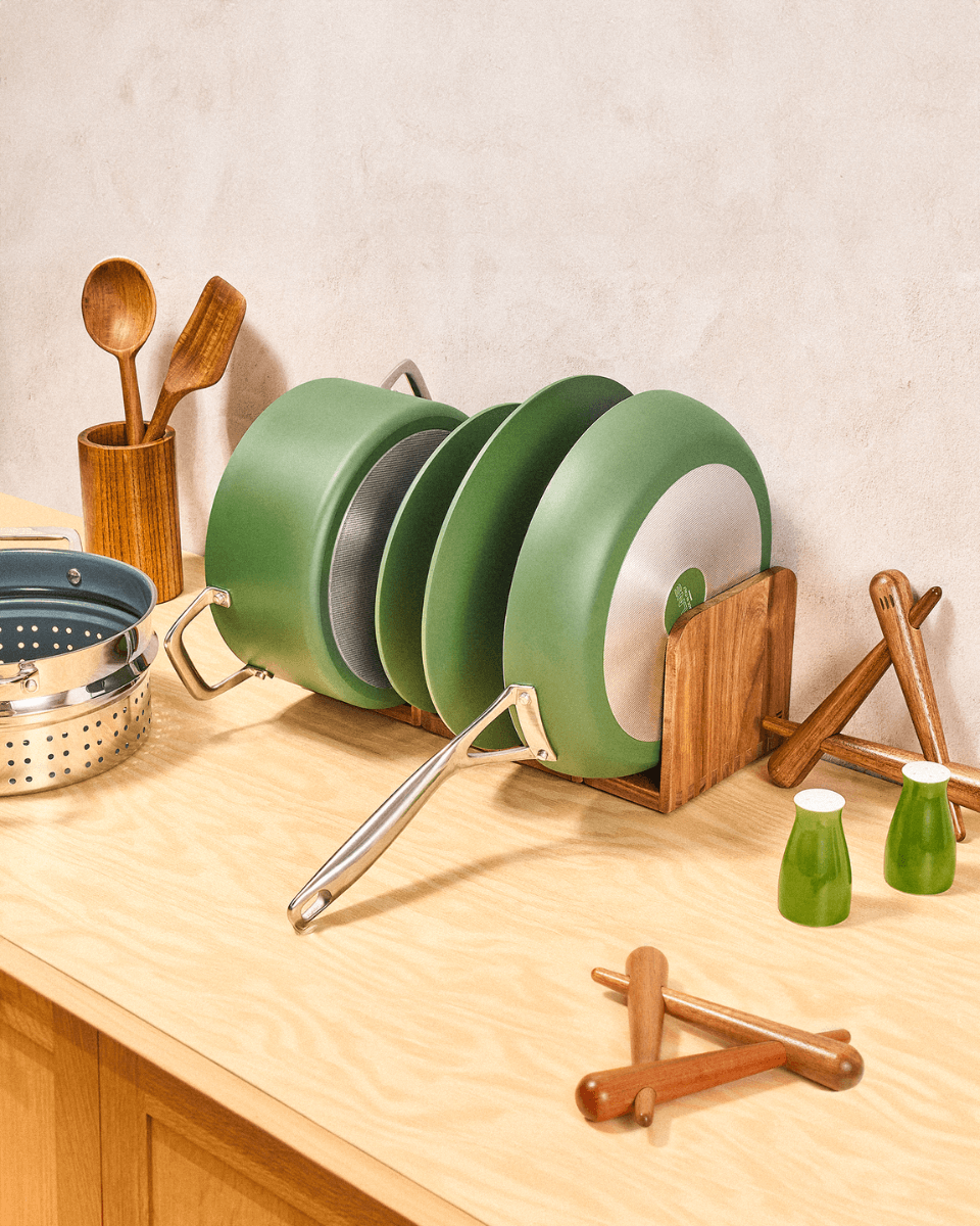 Green pots and pans organized on counter