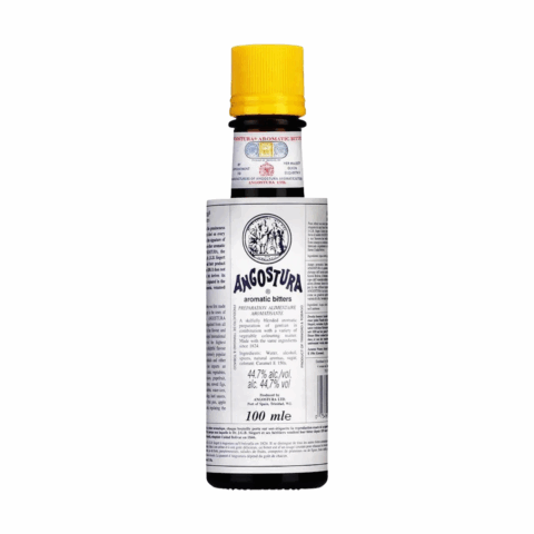 A bottle of bitters with a white label and yellow cap.