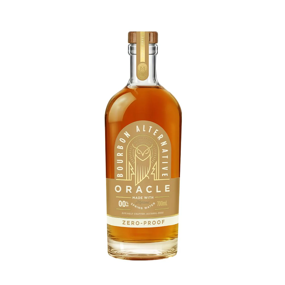 Bottle of amber non-alcoholic bourbon with a cork stopper and tan label. 