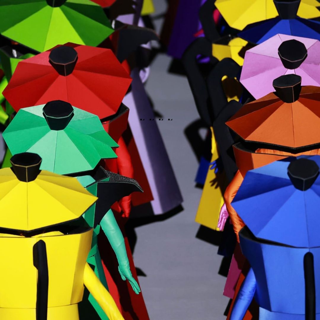 Image of the opening ceremony of the olympics with people dressed as moka pots