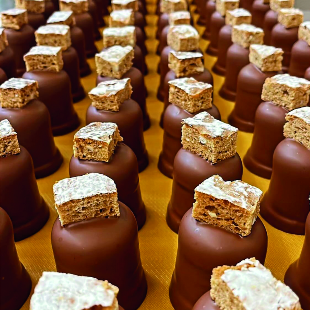 Rows of milk chocolate truffles topped with honeycomb.