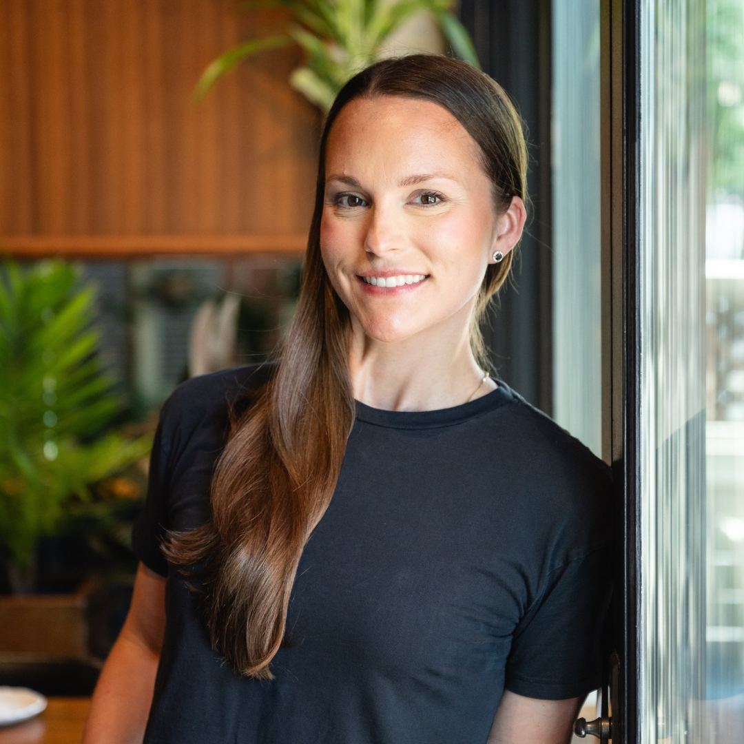 Jennifer Tremblay smiling in a black t-shirt.