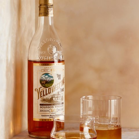 A bottle of Yellowstone bourbon and a glass with some poured