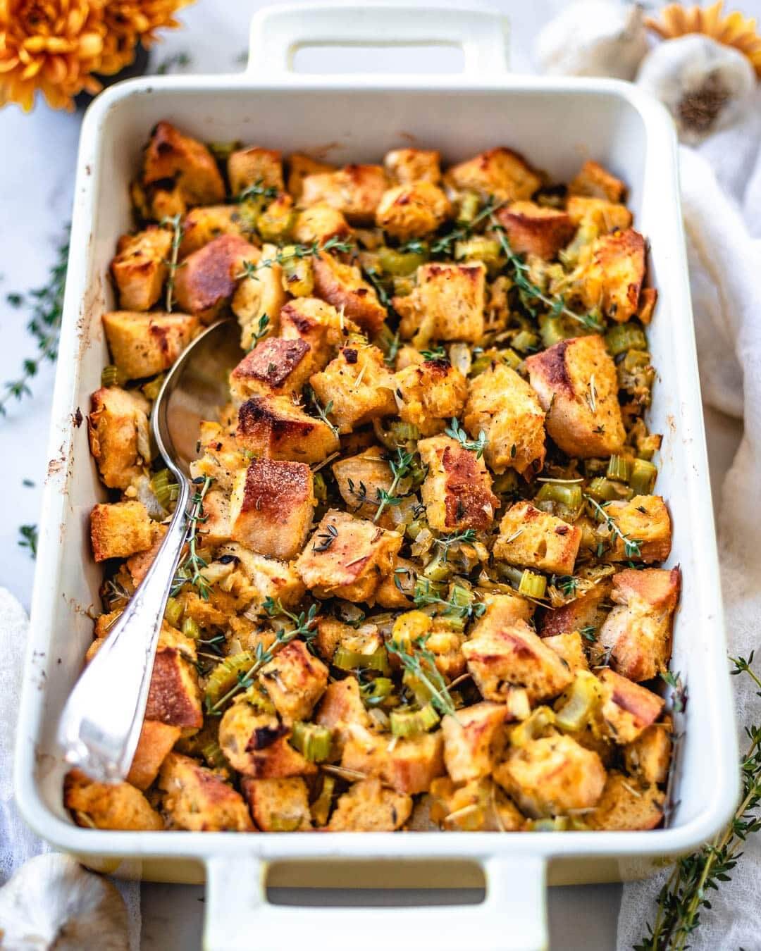 A white baking dish with stuffing in it