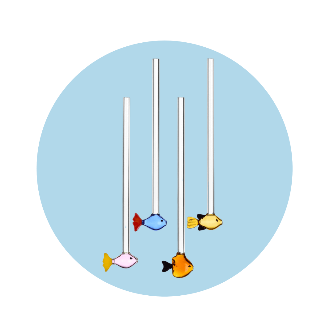 Four glass straws with colourful fish on the bottom. 