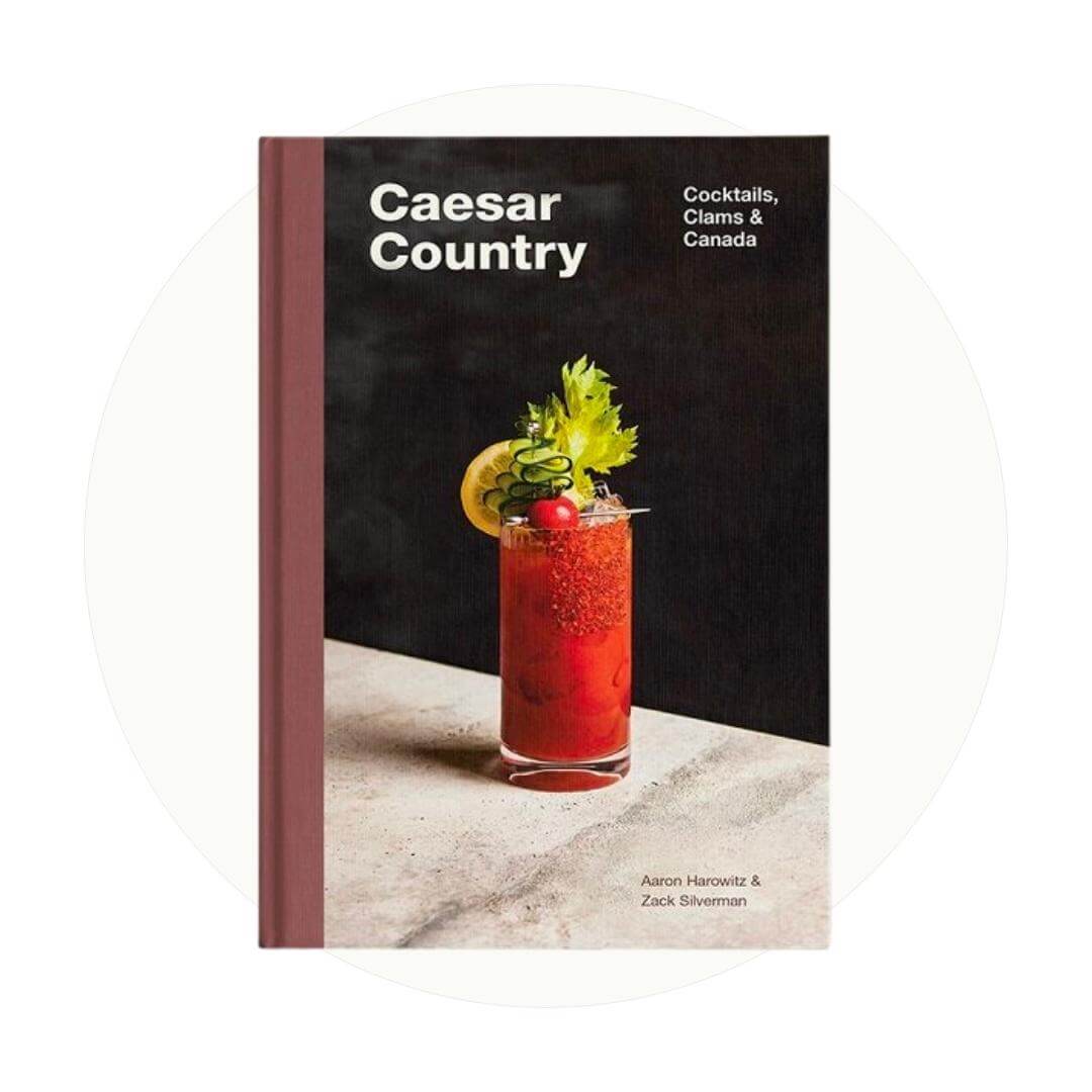 A black book with a Caesar cocktail on an off-white circle graphic