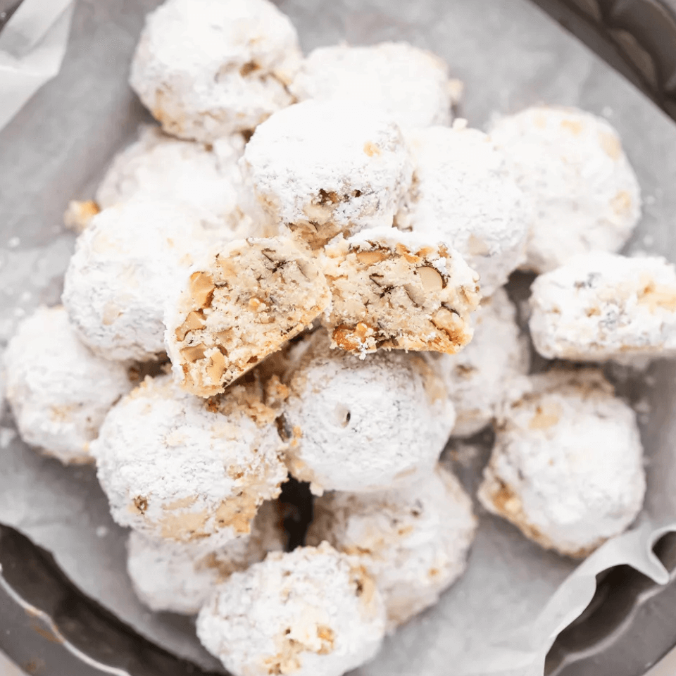 bowl of icing sugar-covered cookies