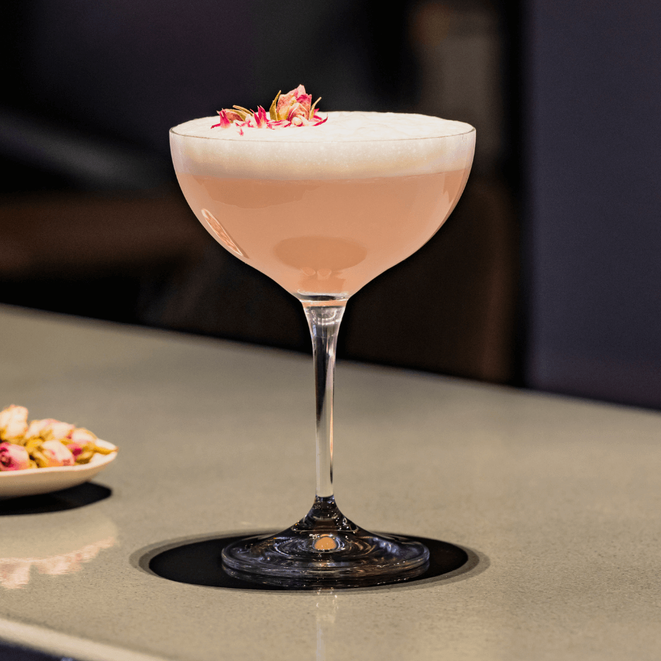 martini glass with pink cocktail rose lychee martini