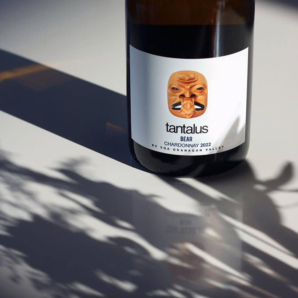 The bottom of a bottle of wine with the label and shadows visible