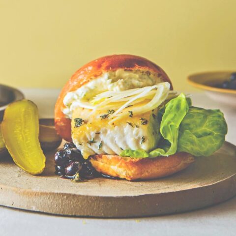 Halibut burger topped with fennel slaw, citrus mayo and blueberry relish on a toasted bun