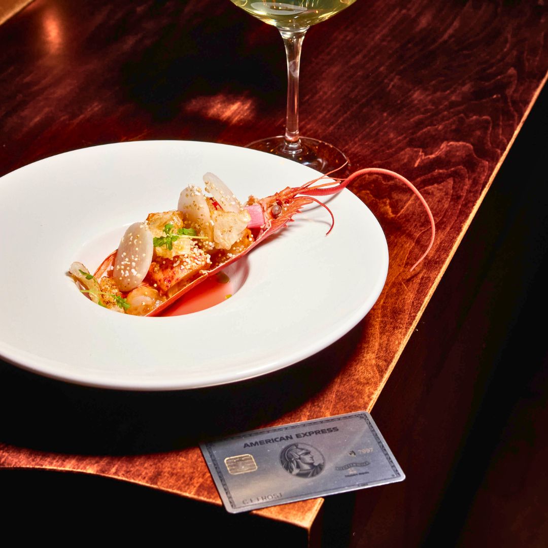 American Express Diners Card sitting next to fine dining meal